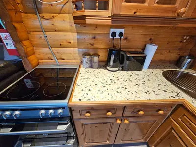 a kitchen with a stove and a counter top at Cosy 2 bedroom Log Cabin in Snowdonia Cabin151 in Trawsfynydd