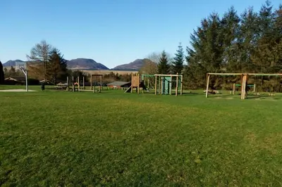 an empty park with a playground with two soccer goals at Cosy 2 bedroom Log Cabin in Snowdonia Cabin151 in Trawsfynydd
