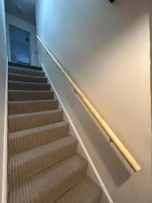 a wooden stick on the wall next to stairs at Avondale in Llangollen