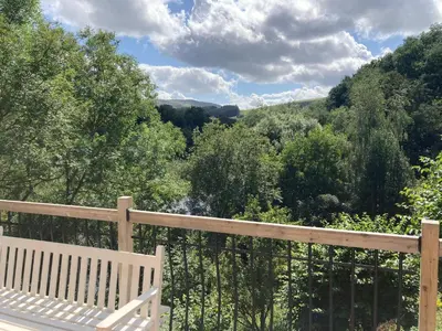 a white bench sitting on top of a wooden railing at Avondale in Llangollen