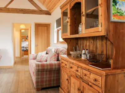 a living room with a couch and a wooden cabinet at Toot View in Ludlow
