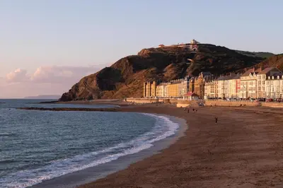 a view of a beach with buildings and the ocean at 1 Bed in Aberystwyth oc-bow285 in Aberystwyth
