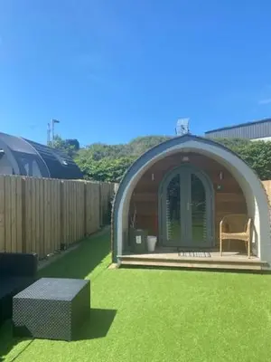 a small gazebo with a bench in the grass at The Pod in Aberystwyth