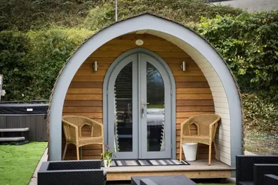 a gazebo with two chairs and a door at The Pod in Aberystwyth