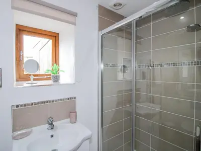 a bathroom with a shower and a sink at Meadow Barn in Craven Arms