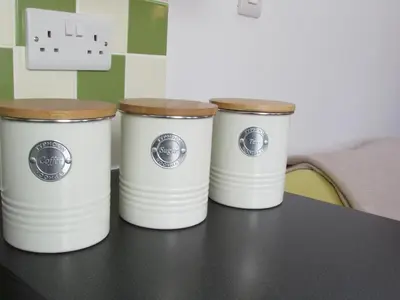 three white buckets sitting on top of a table at Wild Valley Bunkhouse in Llanrhaeadr-ym-Mochnant