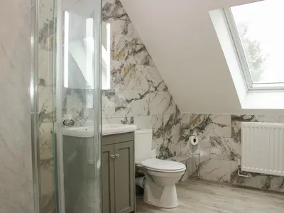 a bathroom with a toilet and a sink at Holly Lodge in Welshpool