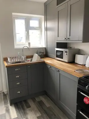 a kitchen with a counter with a microwave and a sink at bwthyn y porthmyn in Llandovery