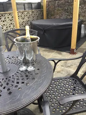 a table with a bottle of wine and two glasses at bwthyn y porthmyn in Llandovery