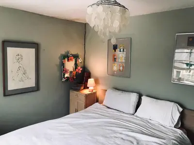 a bedroom with a bed and a chandelier at Half Moon House top flat in Hay-on-Wye