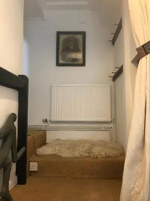 a room with a bed and a picture on the wall at Half Moon House top flat in Hay-on-Wye