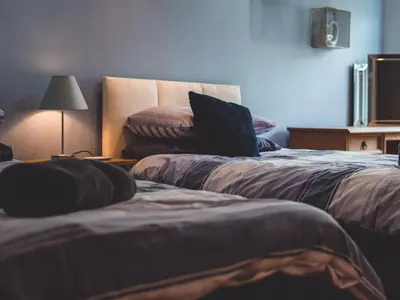 a bedroom with two beds with a laptop on it at The Old Post Office in Llandrindod Wells