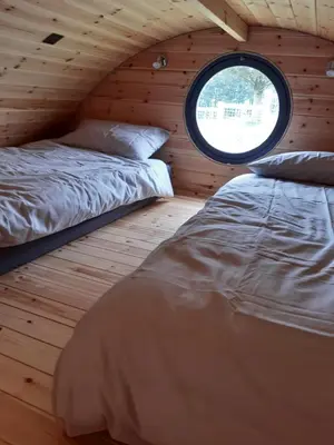 two beds in a room with a window at Penystryd in Trawsfynydd