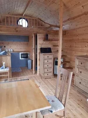 a kitchen in a log cabin with a chair at Penystryd in Trawsfynydd