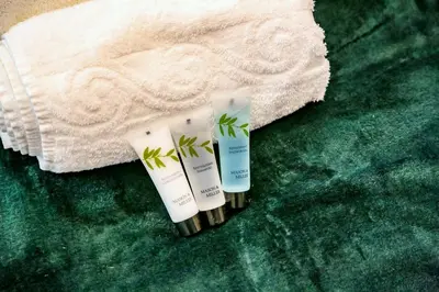 three tubes of sunscreen sitting on a green carpet at Shrewsbury apartments by BEVOLVE - Free Parking in Shrewsbury