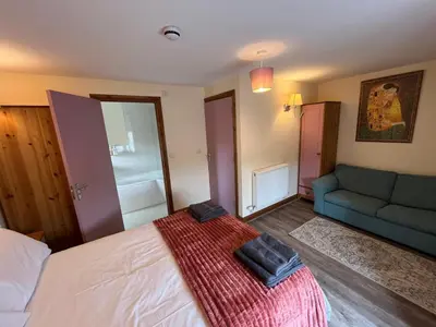 a bedroom with a large bed and a couch at The Star Inn in Dylife