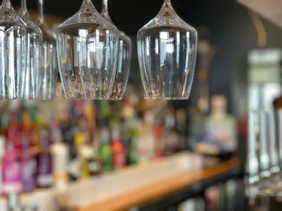 a group of wine glasses hanging from a bar at Y Griffin in Penrhyndeudreath