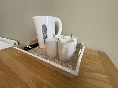 a tray with cups and a pitcher on a table at Y Griffin in Penrhyndeudreath