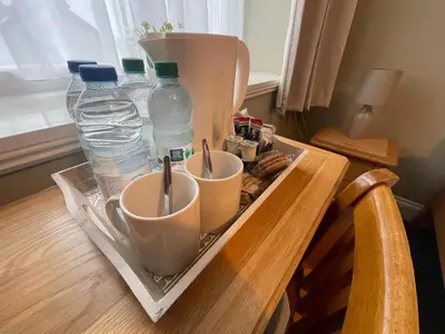 a tray with cups and bottles of water on a table at Y Griffin in Penrhyndeudreath