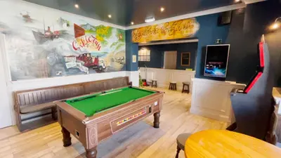 a billiard room with a pool table and a bar at Y Griffin in Penrhyndeudreath