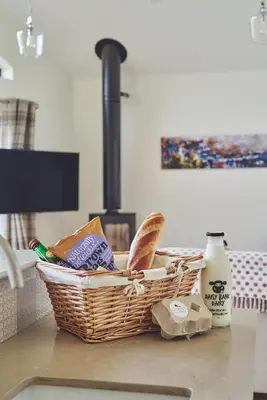 a basket of bread sitting on top of a counter at Lower Tumble Cottage in Llandyssil