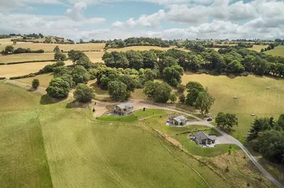 an aerial view of a home in a field at Lower Tumble Cottage in Llandyssil