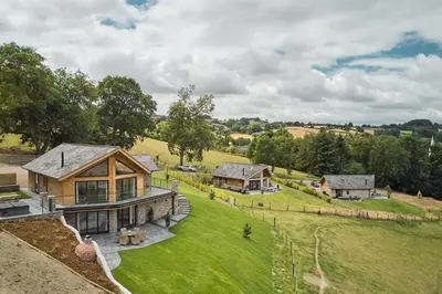 an aerial view of a house with a large yard at Lower Tumble Cottage in Llandyssil