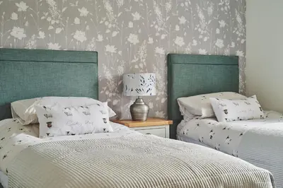 two beds sitting next to each other in a bedroom at Shepherds Rest in Llandyssil