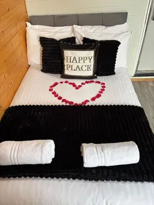 a black and white bed with a happy place sign on it at The Midi Pod in Aberystwyth