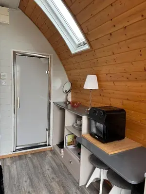 a room with a desk with a computer and a window at The Midi Pod in Aberystwyth