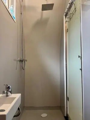 a bathroom with a shower and a sink at The Midi Pod in Aberystwyth