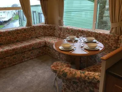 a table and chairs in a room with a couch at D19 in Aberystwyth