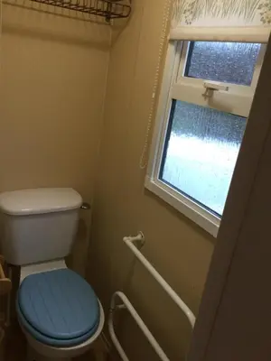 a bathroom with a toilet and a window at D19 in Aberystwyth