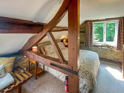 a bedroom with a bunk bed in a house at Stable Cottage in Leintwardine