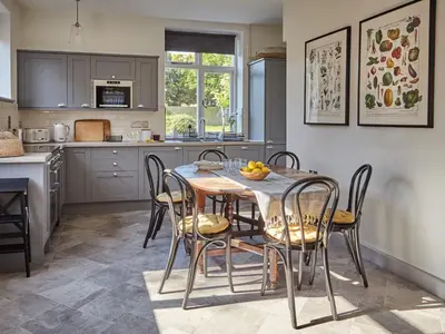 a kitchen and dining room with a table and chairs at Green Acres in Llangollen