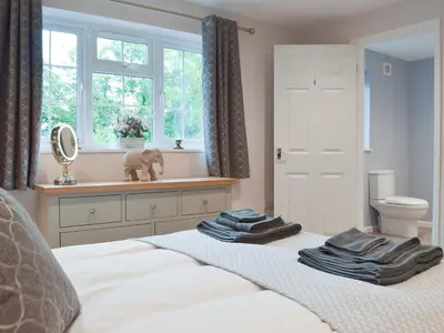 a bedroom with a bed with towels on it at Llain Cottage in Llanina