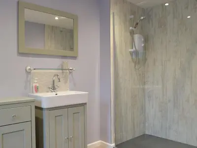 a bathroom with a sink and a shower at Llain Cottage in Llanina