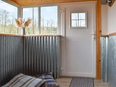 a room with a door and a window at Lower Farm in Llanfihangel Rhydithon