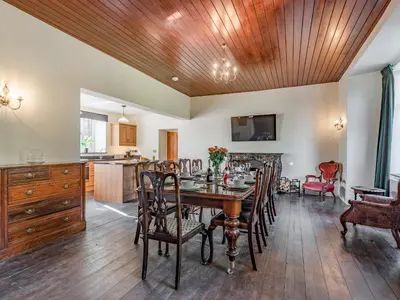 a kitchen and dining room with a table and chairs at Groudd Hall in Cerrigydrudion