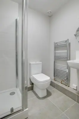 a bathroom with a toilet and a shower and a sink at 4 Bed in Barmouth oc-bow259 in Barmouth