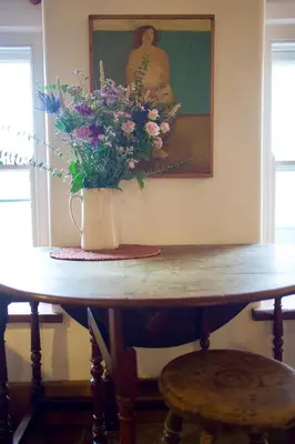 a vase of flowers sitting on top of a table at The Pavement Palace in Hay-on-Wye