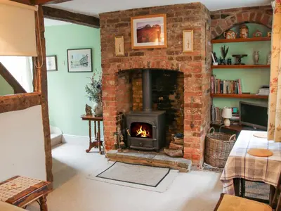 a brick fireplace in a living room with a fire place at 55 Corve Street in Ludlow