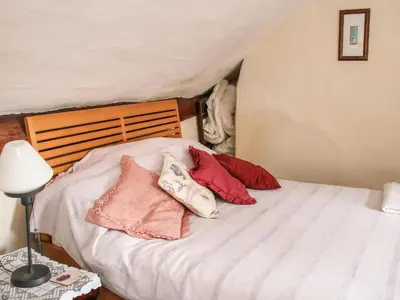 a bedroom with a bed with pillows on it at 55 Corve Street in Ludlow