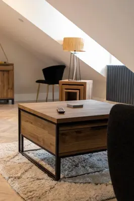 a living room with a coffee table on a rug at Ty Belgrave in Aberystwyth