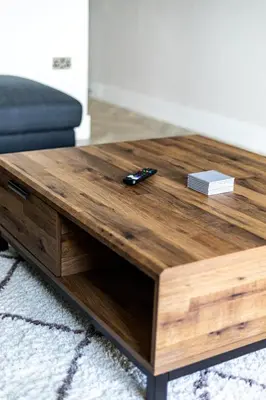 a wooden coffee table in a living room at Ty Belgrave - Apartment 3 in Aberystwyth