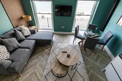 a living room with a couch and a table at Ty Belgrave - Apartment 3 in Aberystwyth