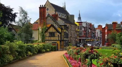 a street in a town with flowers and buildings at Eastridge Glamping - Camping Pods in Shrewsbury