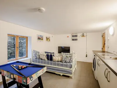 a living room with a pool table and a couch at Hafan Yr Haul in Arthog
