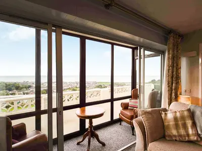 a living room with a view of the ocean at Frondeg in Aberaeron