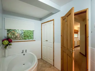 a bathroom with a tub and a window at Brig-Y-Don in Aberaeron